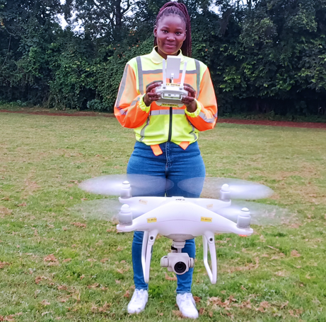 Violet Ochieng flying a drone