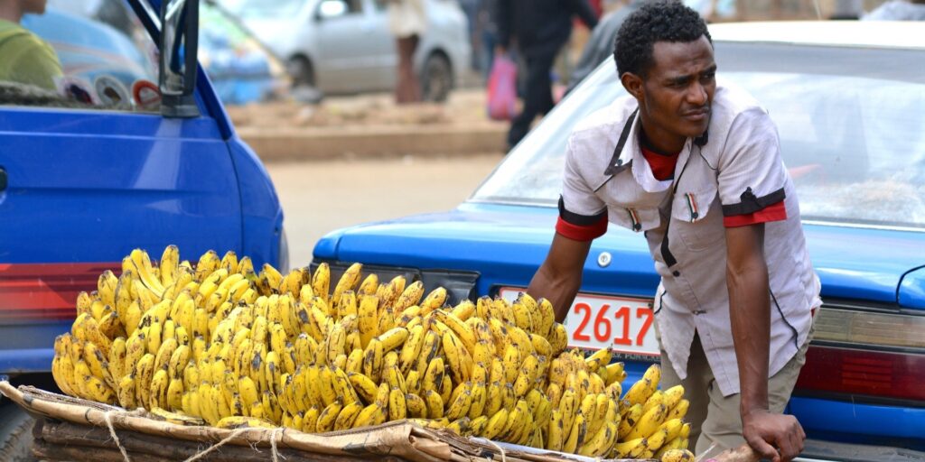 Banana seller looks on (credit: lauradbusiness0, Pixabay)