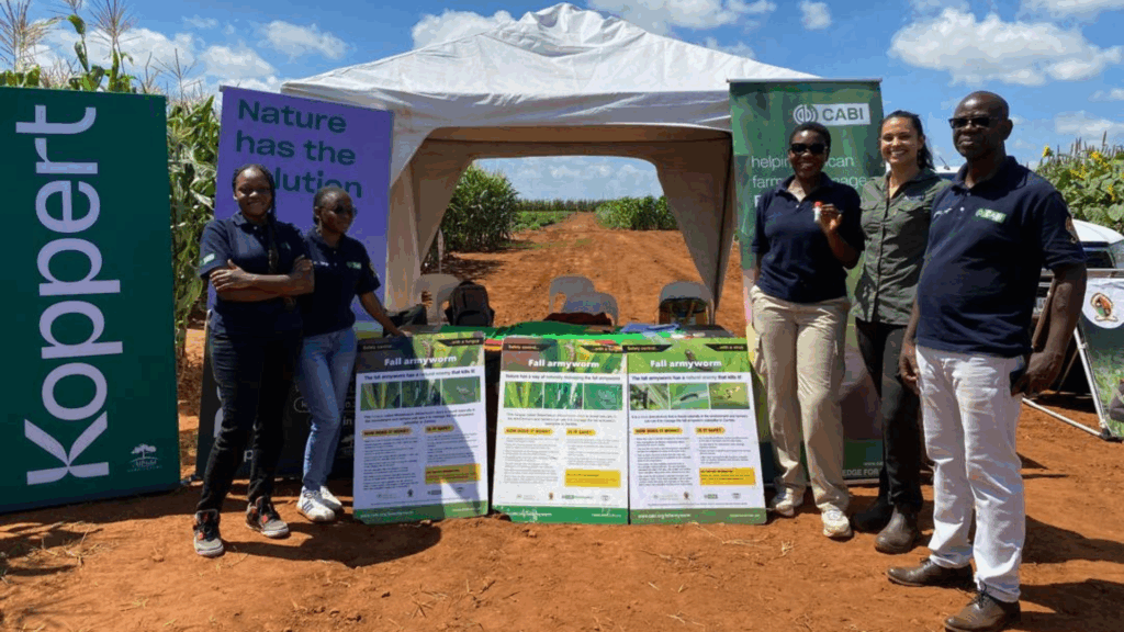 People standing in front of the CABI, UNZA, ZARI and Koppert stand at the Zamseed Field Day