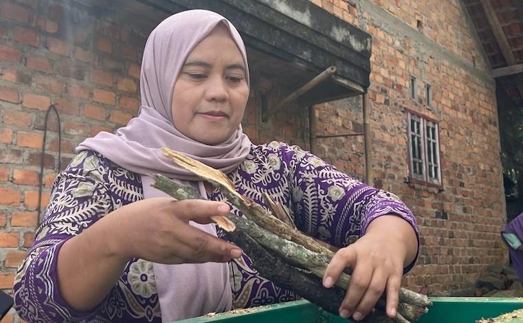 Sustainable agriculture training in Southeast Asia: woman producing biochar