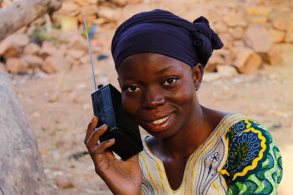 A young female listening to a radio